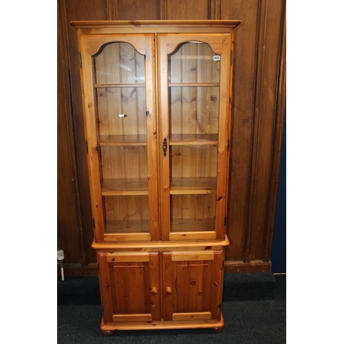 415 - Pine cabinet bookcase, with two glazed doors above two cupboard doors, 81cm wide x 18cm high,