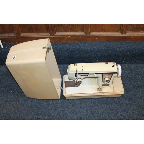 422 - Cased New Home Deluxe sewing machine.