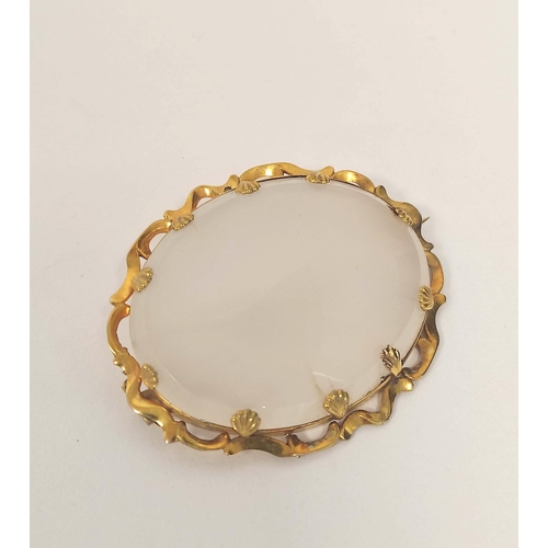 65 - Victorian oval white chalcedony brooch in gold wavy mount, probably 15ct, 63mm x 54mm. 42g gross.