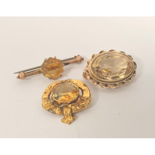 69 - Citrine oval brooch, a similar pin, both 9ct gold and a brooch with garter mount. 14g gross (2).