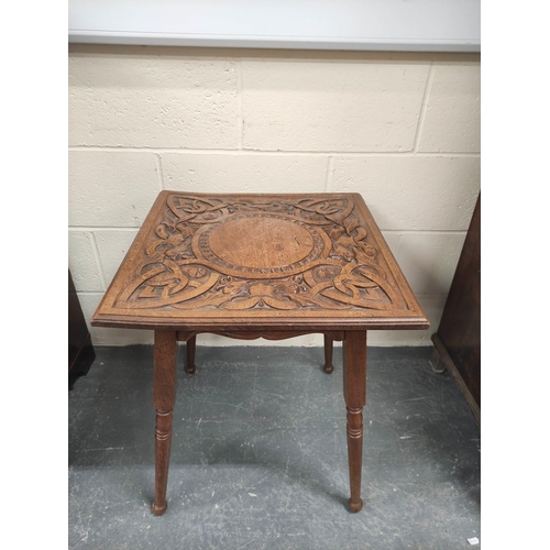 473 - Arts & Crafts style square oak occasional table, c.1900, the top carved with scrolls and bird ma... 