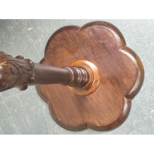 479 - Edwardian mahogany wine table, the lobed circular top on ring and leaf carved turned column with dow... 