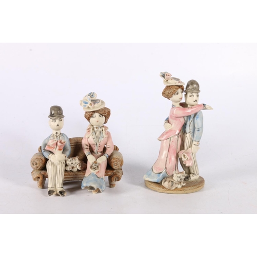 34 - Laura Dunn Studio Pottery figure groups of a husband and wife with cat, 13cm and 10cm tall.  (2... 