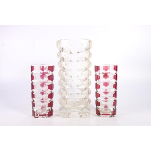 69 - Three french art moulded glass vases with faceted decoration, tallest measures 25cm.