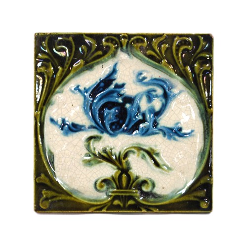 Collection of glazed ceramic tiles to include William de Morgan-style tile with floral decoration.  (20)