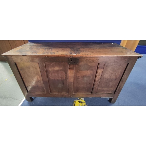 464 - Antique oak coffer, plank top above four panel front on stile supports. H.80cm, W.147cm, D.57cm.