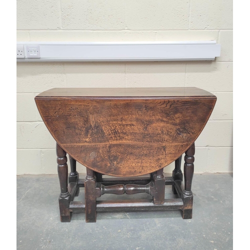 476 - 17th century oak oval small drop leaf dining table on turned baluster supports and understretchers. ... 