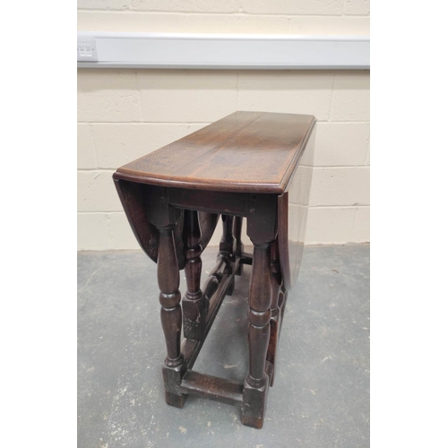 476 - 17th century oak oval small drop leaf dining table on turned baluster supports and understretchers. ... 