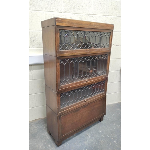 483 - Oak stacking bookcase by Globe Wernicke, the four sections with leaded glass doors, raised on base, ... 