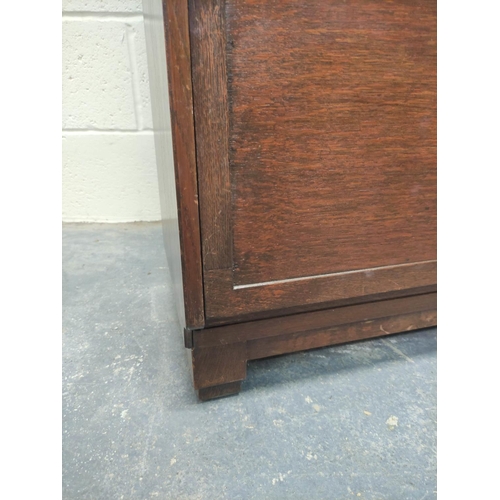 483 - Oak stacking bookcase by Globe Wernicke, the four sections with leaded glass doors, raised on base, ... 