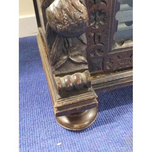 497 - Victorian stained oak glazed bookcase with twin doors, carved with mask heads , fruit, flora and fol... 