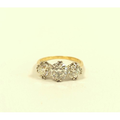 100 - Fine diamond three stone ring the central brilliant 8mm, (approximately 1.6ct), faceted girdle, flan... 