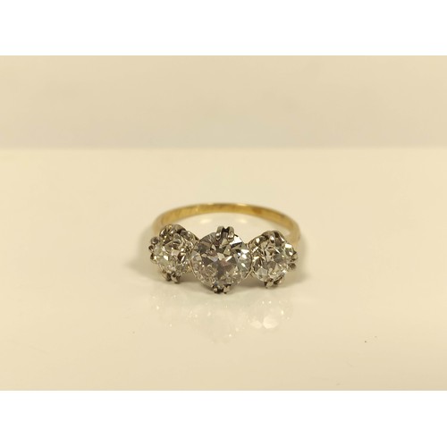 100 - Fine diamond three stone ring the central brilliant 8mm, (approximately 1.6ct), faceted girdle, flan... 