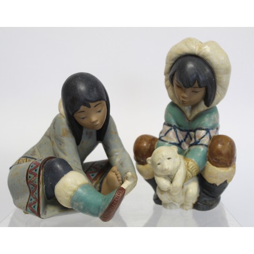 232A - Two Lladro Gres figures of Inuit children, one crouching with polar bear cub, 20.5cm high, the other... 