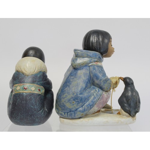 232B - Two Lladro Gres figures of Inuit children, one crouching beside an ice fishing hole with penguin, 20... 