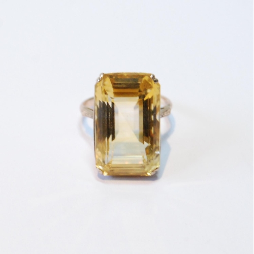 107 - Ring with rectangular large citrine in pierced box setting, probably 14ct gold, size J.