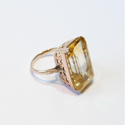 107 - Ring with rectangular large citrine in pierced box setting, probably 14ct gold, size J.