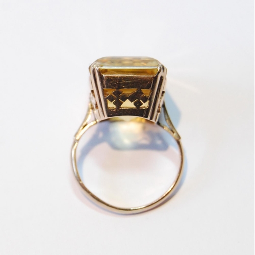 107 - Ring with rectangular large citrine in pierced box setting, probably 14ct gold, size J.