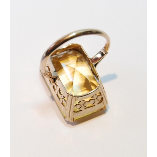 107 - Ring with rectangular large citrine in pierced box setting, probably 14ct gold, size J.