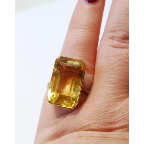 107 - Ring with rectangular large citrine in pierced box setting, probably 14ct gold, size J.