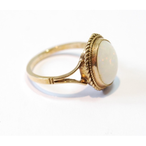 112 - Opal ring in 9ct gold with rope edge, size O.