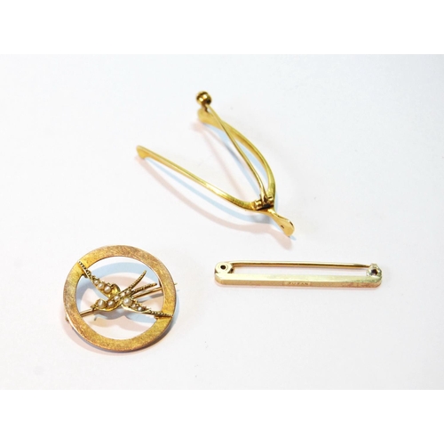 114 - Gold circular brooch with pearl-set swallow, '9ct', a wishbone brooch, probably 15ct, and a 9ct gold... 