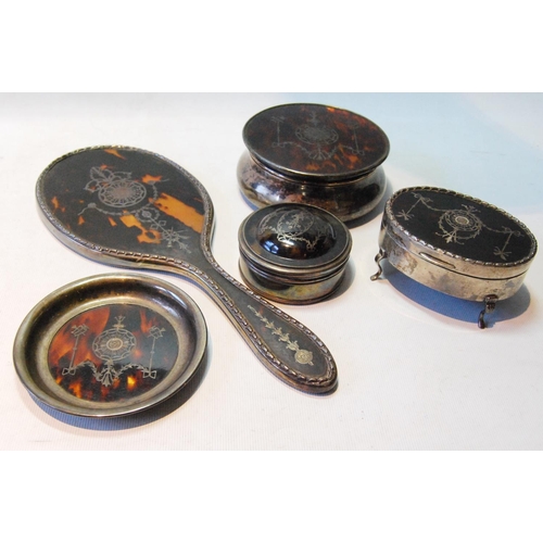 115 - Silver inlaid tortoiseshell toilet set comprising an oval bijouterie box on legs, 9cm, another, circ... 