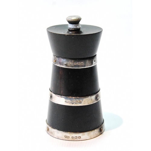 118 - Silver-mounted lignum vitae pepper mill of churn shape by Saunders and Shepherd, Birmingham 1936.