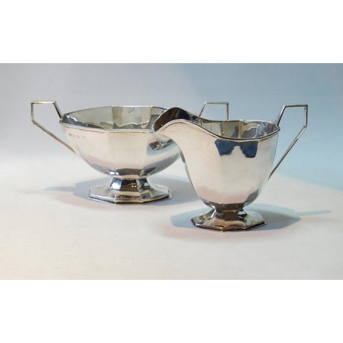 122 - Silver sugar bowl of panelled boat shape and the matching milk jug, by Elkington & Co., Birmingh... 