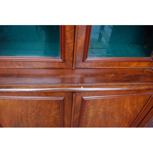 388 - Victorian mahogany library bookcase with two arched glazed doors enclosing a shelved interior, flank... 