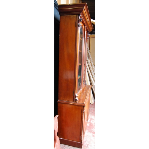 388 - Victorian mahogany library bookcase with two arched glazed doors enclosing a shelved interior, flank... 