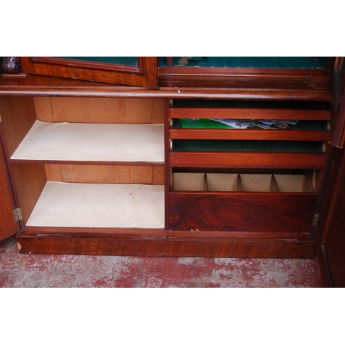 388 - Victorian mahogany library bookcase with two arched glazed doors enclosing a shelved interior, flank... 