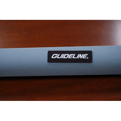 179 - Guideline LPX three-piece graphite fishing rod, in canvas bag with outer tube.