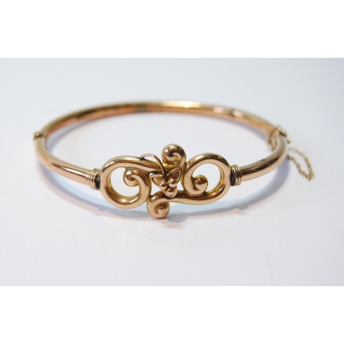 69 - Gold hinged bangle with beaded scrolls, '9ct', 7.6g, cased.