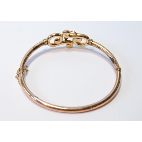 69 - Gold hinged bangle with beaded scrolls, '9ct', 7.6g, cased.