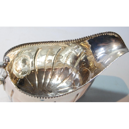 82 - Irish silver sauce boat of large size, crested, with waved flutes and punch bead border, on pad feet... 