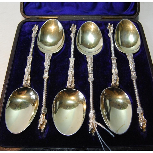 88 - Set of six silver dessert spoons, parcel gilt, with spiral handles and figure terminals, by Martin &... 