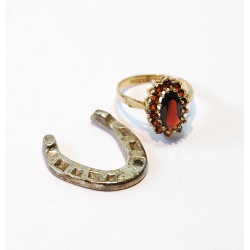 94 - Garnet navette cluster ring in 9ct gold, size N, and a silver horseshoe charm, 1932.  (2)