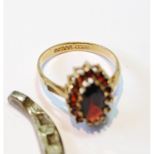 94 - Garnet navette cluster ring in 9ct gold, size N, and a silver horseshoe charm, 1932.  (2)