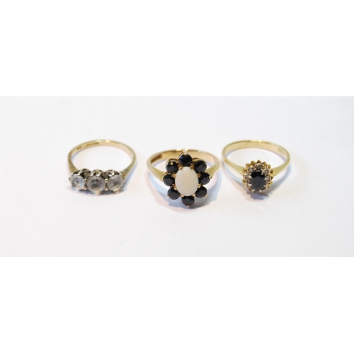 96 - Opal and sapphire cluster ring, another, and a three-stone paste ring, all 9ct gold.  (3)