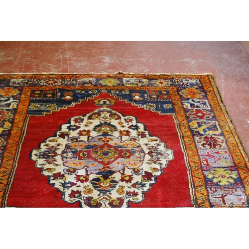 317 - Old Turkish Konya rug decorated with a central floral medallion and geometric and floral motifs to t... 