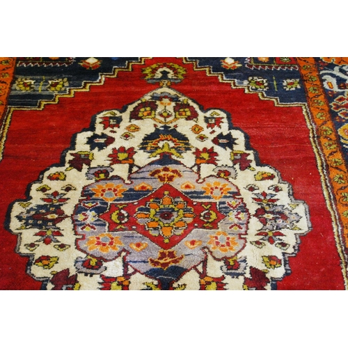 317 - Old Turkish Konya rug decorated with a central floral medallion and geometric and floral motifs to t... 