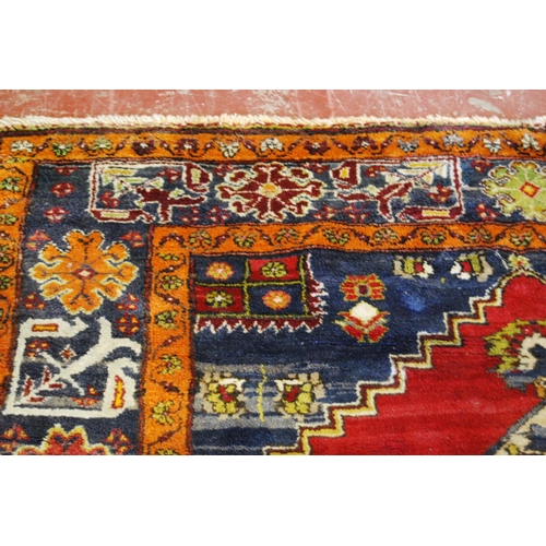 317 - Old Turkish Konya rug decorated with a central floral medallion and geometric and floral motifs to t... 