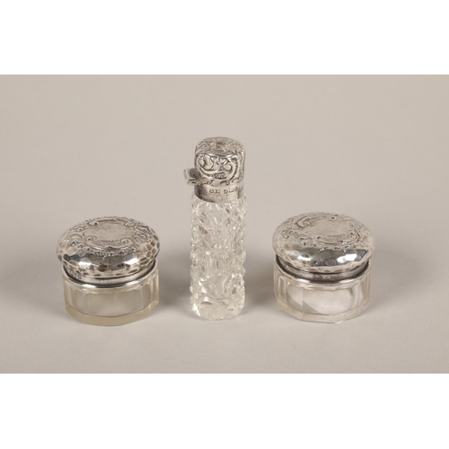 205 - Three silver topped dressing table jars