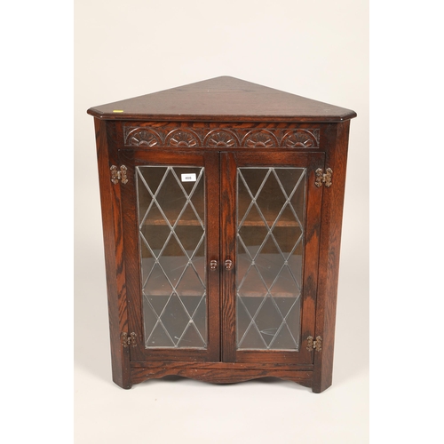 408 - Carved oak two door corner cabinet