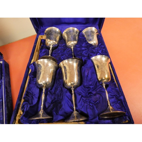 289 - Twelve epns wine goblets, in blue velvet cases.