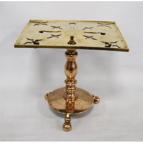 204 - Georgian brass trivet with a square pierced top, on turned column, circular base and tripod ball fee... 