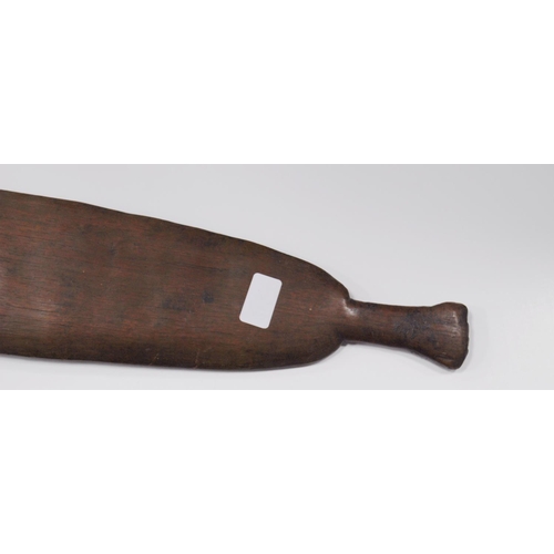 214 - Aboriginal fish tail paddle club (Rainforest sword), with shaped grip, 147.5cm long and 13.5cm wide.