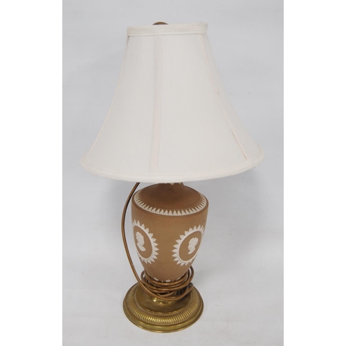 235 - Wedgwood brown Jasper ware table lamp decorated with classical masks, on brass circular foot, approx... 