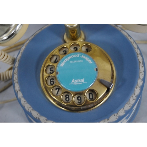 238 - Wedgwood blue Jasper ware telephone decorated with classical figures and putti, 18cm high.